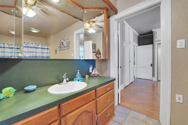121 S Randlett St, Hobart, OK 73651 - bathroom featuring a textured wall, tile patterned flooring, vanity, and a ceiling fan