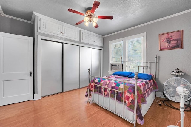 121 S Randlett St, Hobart, OK 73651 - bedroom featuring crown molding, a closet, light wood-type flooring, and a textured ceiling