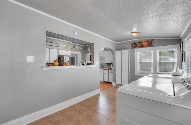121 S Randlett St, Hobart, OK 73651 - kitchen featuring freestanding refrigerator, arched walkways, a textured ceiling, tile patterned floors, and a textured wall
