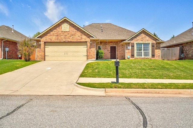 73 Bonaire Dr, Edmond, OK 73013 - view of front of property with an attached garage, concrete driveway, brick siding, and roof with shingles