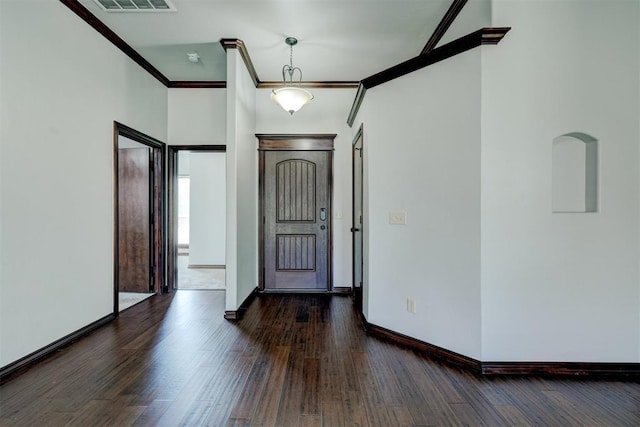 73 Bonaire Dr, Edmond, OK 73013 - foyer featuring dark wood finished floors, ornamental molding, and baseboards