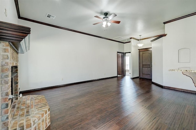 73 Bonaire Dr, Edmond, OK 73013 - unfurnished living room with a ceiling fan, crown molding, wood finished floors, baseboards, and a fireplace with raised hearth