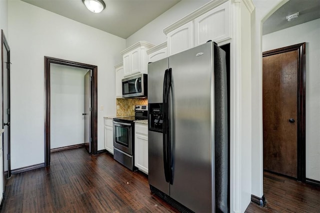 73 Bonaire Dr, Edmond, OK 73013 - kitchen with appliances with stainless steel finishes, white cabinetry, dark wood-style floors, tasteful backsplash, and baseboards