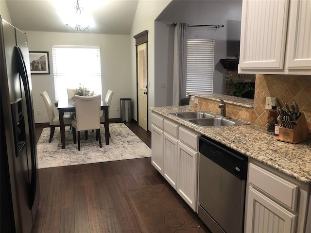 73 Bonaire Dr, Edmond, OK 73013 - kitchen featuring appliances with stainless steel finishes, a sink, dark wood-style floors, backsplash, and white cabinetry