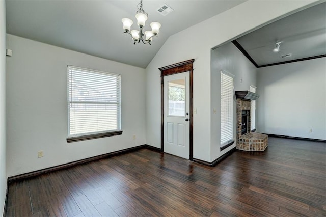 73 Bonaire Dr, Edmond, OK 73013 - unfurnished living room with a chandelier, vaulted ceiling, dark wood-style floors, a fireplace, and baseboards