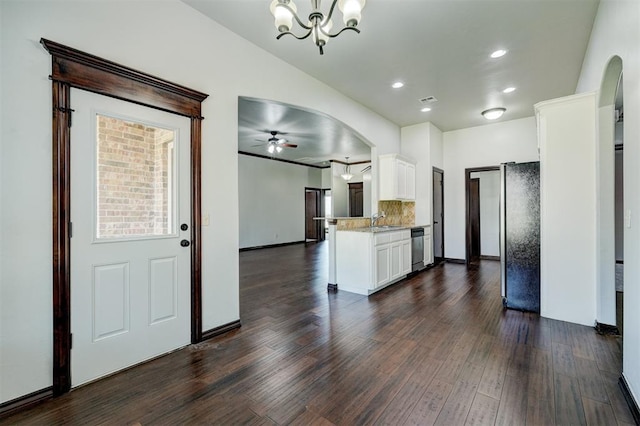 73 Bonaire Dr, Edmond, OK 73013 - kitchen with a sink, white cabinets, stainless steel dishwasher, a chandelier, and dark wood-style flooring