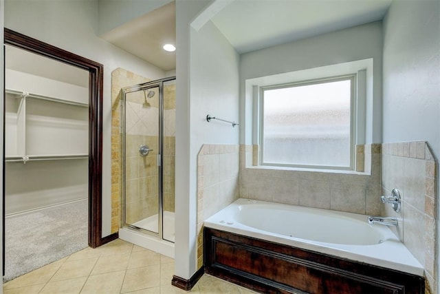 73 Bonaire Dr, Edmond, OK 73013 - bathroom featuring a shower stall, a walk in closet, tile patterned floors, and a bath