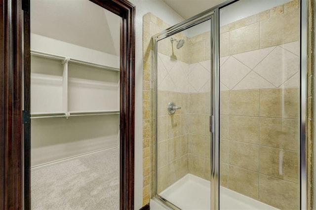73 Bonaire Dr, Edmond, OK 73013 - bathroom featuring a stall shower and a walk in closet