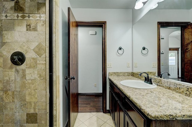 73 Bonaire Dr, Edmond, OK 73013 - bathroom with a tile shower, tile patterned flooring, and vanity