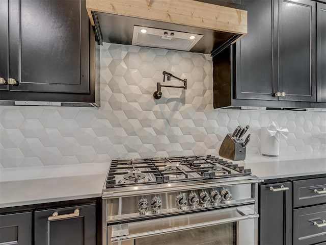 1330 Acclivis Ct, Newcastle, OK 73065 - kitchen with wall chimney range hood, stainless steel gas stove, light countertops, and decorative backsplash