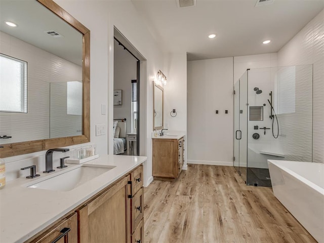 1330 Acclivis Ct, Newcastle, OK 73065 - full bathroom with a stall shower, wood finished floors, a sink, and visible vents