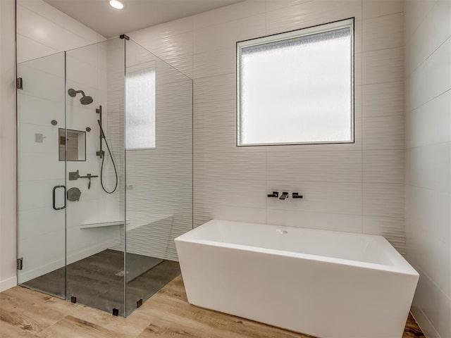 1330 Acclivis Ct, Newcastle, OK 73065 - bathroom with a shower stall, a soaking tub, wood finished floors, and a wealth of natural light