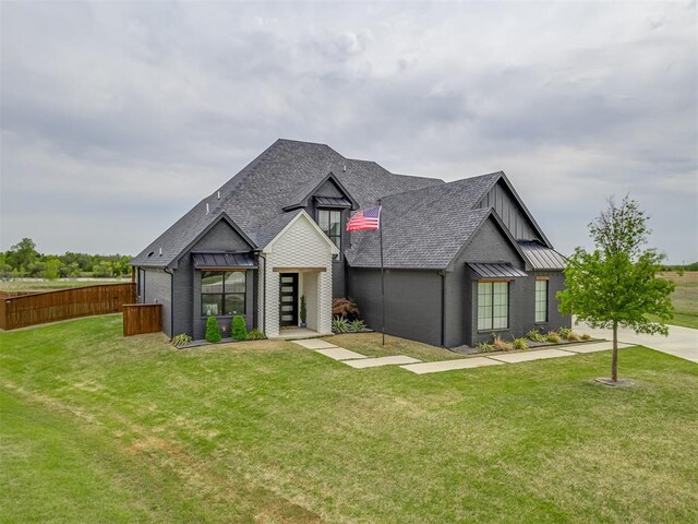1330 Acclivis Ct, Newcastle, OK 73065 - view of front facade featuring a front lawn, fence, a standing seam roof, and roof with shingles