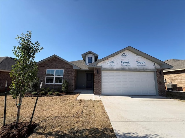 2329 SE 89th Ter, Oklahoma City, OK 73160 - view of front of house featuring a garage, brick siding, and concrete driveway