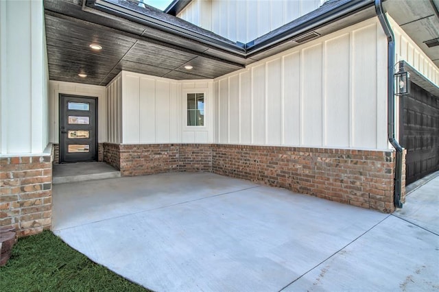 exterior space featuring board and batten siding and brick siding