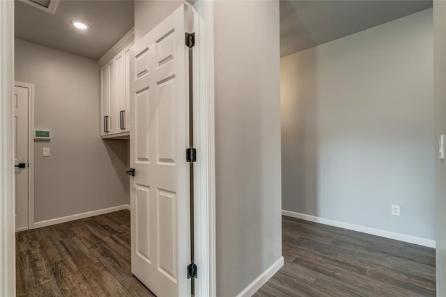hall featuring recessed lighting, baseboards, and dark wood finished floors