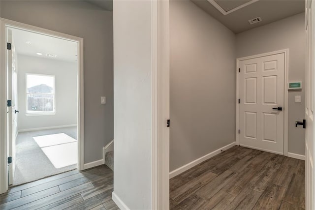 interior space featuring visible vents, baseboards, and wood finished floors