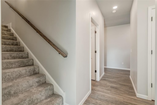 stairs featuring baseboards, recessed lighting, and wood finished floors