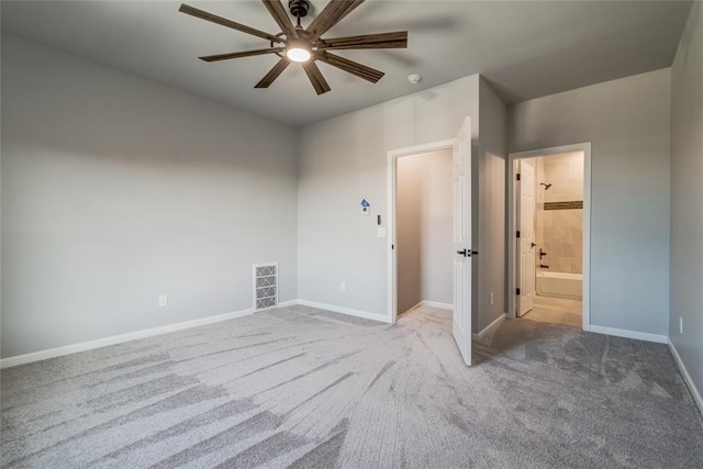 carpeted empty room with visible vents, baseboards, and a ceiling fan