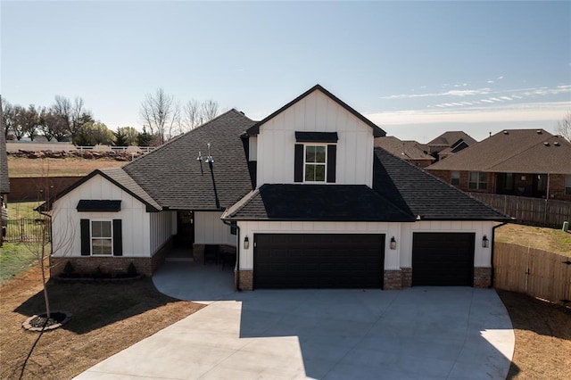 modern inspired farmhouse with concrete driveway, board and batten siding, fence, and a shingled roof