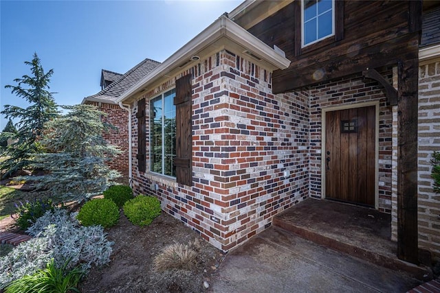 property entrance featuring brick siding