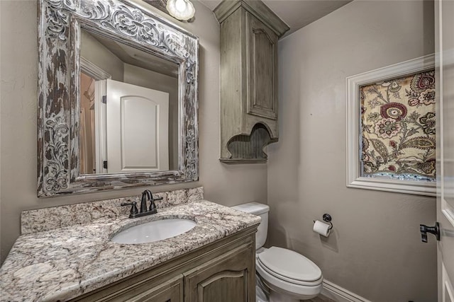 half bath featuring toilet and vanity