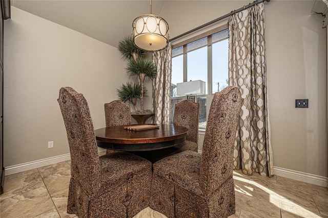 dining room with marble finish floor and baseboards
