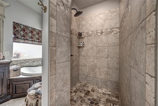 bathroom with a tile shower and a garden tub