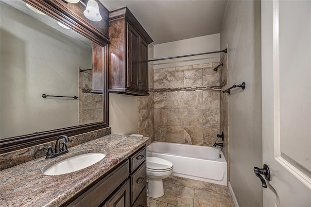 bathroom featuring toilet, vanity, baseboards, and shower / bathtub combination