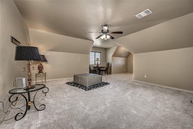 additional living space with visible vents, baseboards, a ceiling fan, carpet, and vaulted ceiling
