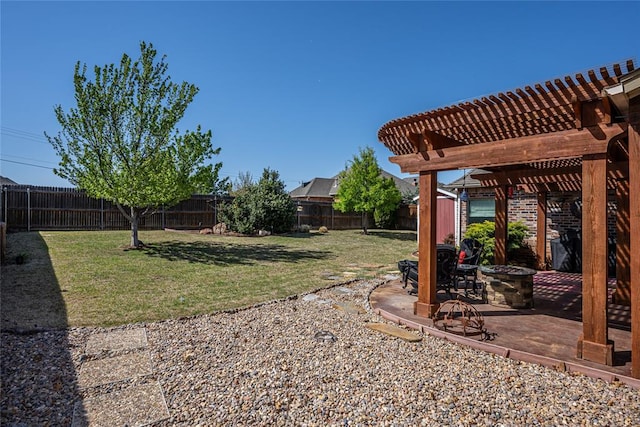 view of yard featuring a patio area, a fenced backyard, a fire pit, and a pergola