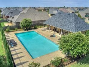 view of swimming pool featuring a fenced backyard, a fenced in pool, a residential view, and a patio area
