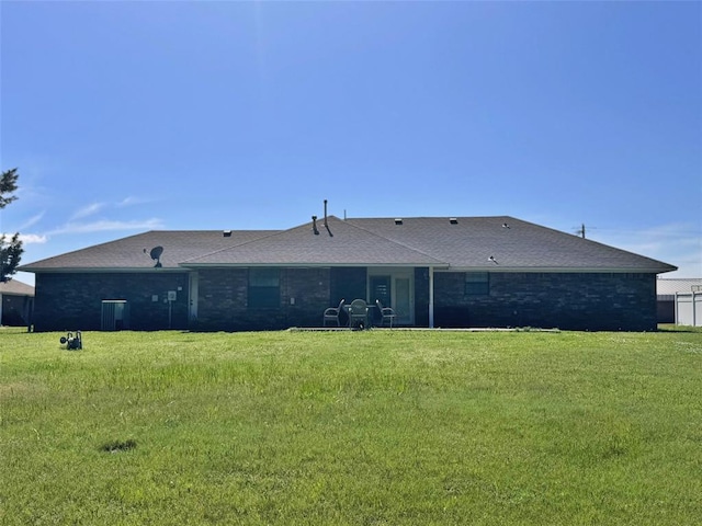 705 Cambridge Dr, Sulphur, OK 73086 - rear view of house featuring a lawn and roof with shingles