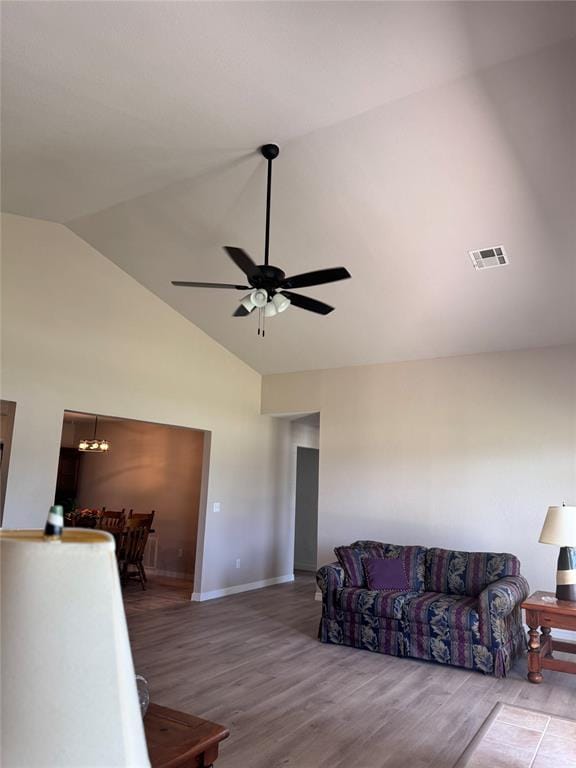 705 Cambridge Dr, Sulphur, OK 73086 - living room with high vaulted ceiling, ceiling fan with notable chandelier, baseboards, wood finished floors, and visible vents