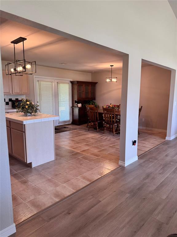 705 Cambridge Dr, Sulphur, OK 73086 - kitchen featuring an inviting chandelier, light wood-style flooring, and baseboards