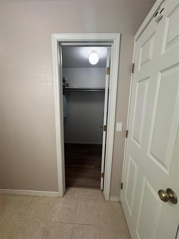 705 Cambridge Dr, Sulphur, OK 73086 - corridor featuring baseboards and light tile patterned flooring