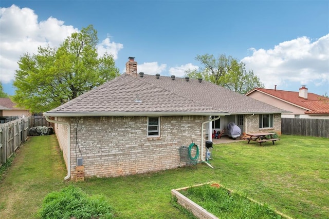10404 Durham Dr, Oklahoma City, OK 73162 - back of property with a shingled roof, a lawn, a chimney, a fenced backyard, and brick siding