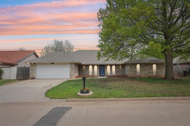 10404 Durham Dr, Oklahoma City, OK 73162 - ranch-style home with a lawn, fence, brick siding, an attached garage, and concrete driveway
