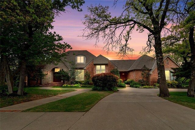 3920 Creek Bank Dr, Edmond, OK 73003 - traditional-style house featuring brick siding, a lawn, and concrete driveway