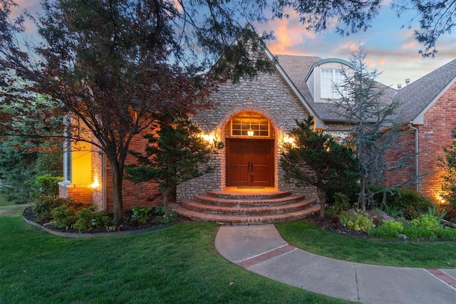 3920 Creek Bank Dr, Edmond, OK 73003 - view of front of home with stone siding, a lawn, and brick siding