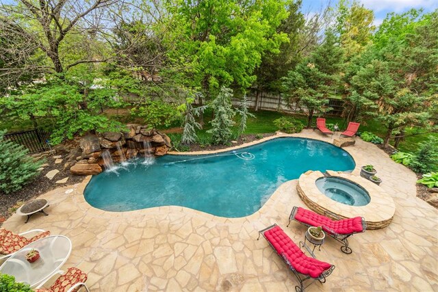 3920 Creek Bank Dr, Edmond, OK 73003 - view of pool with a patio, a fenced backyard, a pool with connected hot tub, and view of scattered trees
