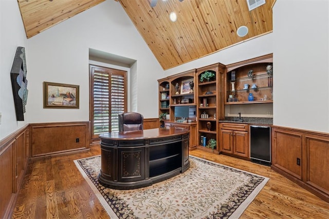 3920 Creek Bank Dr, Edmond, OK 73003 - home office with a wainscoted wall, high vaulted ceiling, wood ceiling, and light wood finished floors
