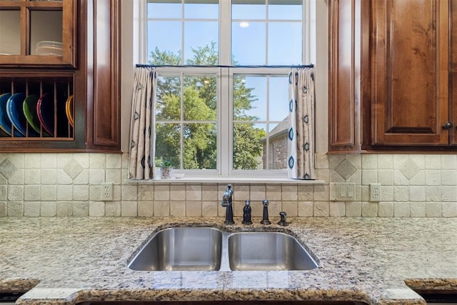 3920 Creek Bank Dr, Edmond, OK 73003 - kitchen featuring light stone counters and decorative backsplash