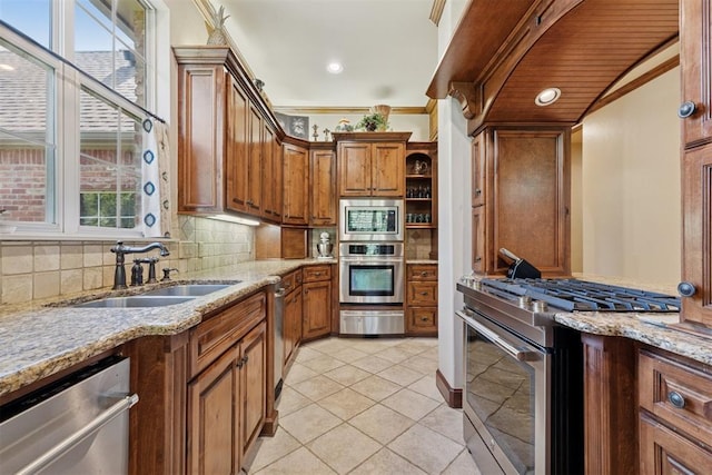 3920 Creek Bank Dr, Edmond, OK 73003 - kitchen featuring appliances with stainless steel finishes, a warming drawer, decorative backsplash, brown cabinets, and light tile patterned floors