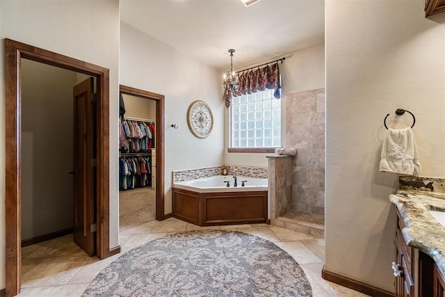3920 Creek Bank Dr, Edmond, OK 73003 - full bath with a garden tub, tile patterned floors, vanity, walk in shower, and a spacious closet