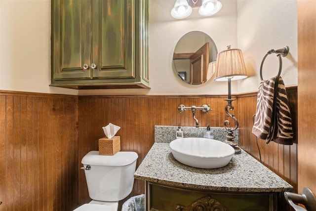 3920 Creek Bank Dr, Edmond, OK 73003 - half bathroom featuring vanity, a wainscoted wall, and wood walls