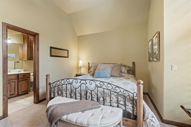 3920 Creek Bank Dr, Edmond, OK 73003 - bedroom with lofted ceiling, light carpet, and ensuite bathroom