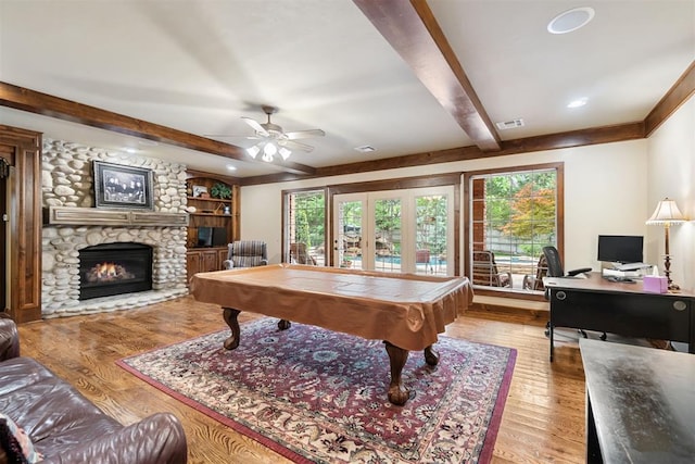 3920 Creek Bank Dr, Edmond, OK 73003 - rec room with beamed ceiling, wood finished floors, a stone fireplace, billiards, and a ceiling fan