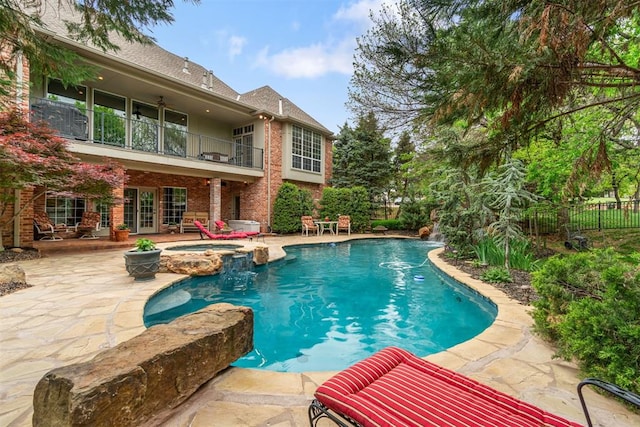 3920 Creek Bank Dr, Edmond, OK 73003 - view of swimming pool featuring a patio area, french doors, and a pool with connected hot tub