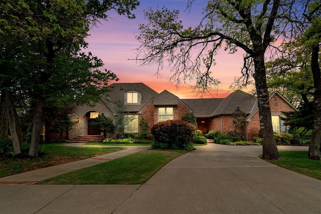 3920 Creek Bank Dr, Edmond, OK 73003 - traditional home featuring brick siding, a front lawn, and driveway